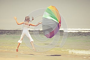 Teen girl jumping on the beach