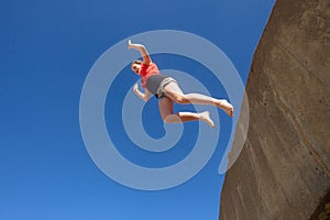 Teen Girl Jumping Blue Sky