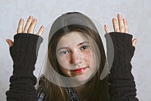 Teen girl in knitted brown glows close up portrait