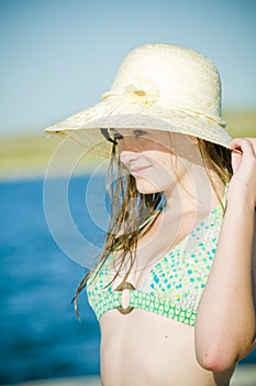 Teen girl at lake with sunhat photo