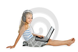 Teen girl on laptop with earphones