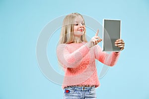 Teen girl with laptop. Love to computer concept. Attractive female half-length front portrait, trendy blue studio