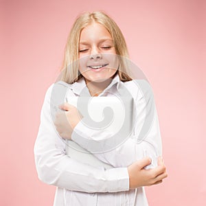 Teen girl with laptop. Love to computer concept. Attractive female half-length front portrait, trendy pink studio