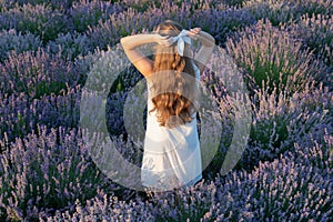 teen girl in lavender flowers with long hair outdoor. teen girl in lavender field.