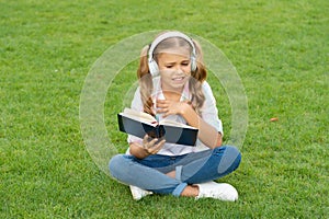 teen girl lifestyle. tween dislike the book. relax in park. music education while listening. lifestyle of teenager girl