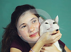 Teen girl with long brown hair and cat