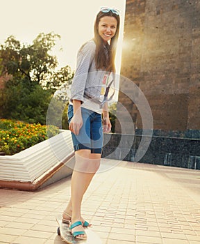 Teen girl on longboard on the street