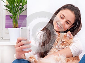 Girl makes selfie with a cat.