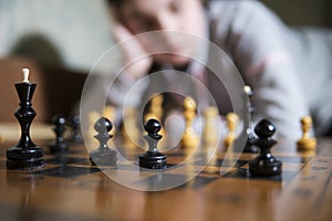 Teen girl making checkmate playing chess