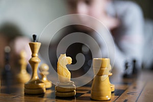 Teen girl making checkmate playing chess