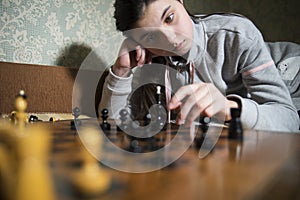 Teen girl making checkmate playing chess