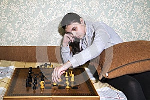 Teen girl making checkmate playing chess