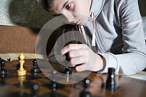 Teen girl making checkmate playing chess