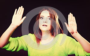 Teen girl making stop gesture on black