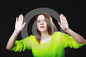 Teen girl making stop gesture on black