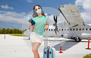 Teen girl in mask with travel bag and air ticket