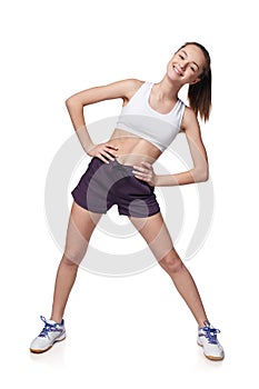 Teen girl measuring her waist with a measuring tape