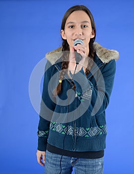 Teen girl with microphone singing