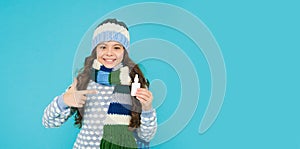 teen girl with nasal spray. no addiction to medicals. copy space. kid in warm sweater feel cold