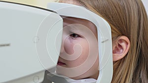 teen girl in ophthalmologist's office. computed tomography of the eye