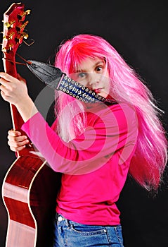 Teen girl with pink hair playing guitar