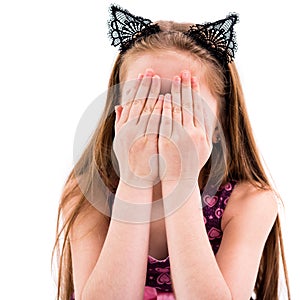 Teen girl playing hide-and-seek, covering her face