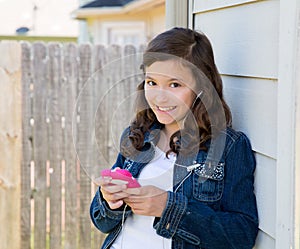 Teen girl playing music with smartphone earings