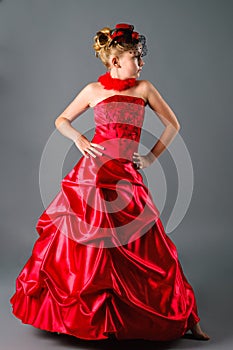 Teen girl posing in prom dress in studio