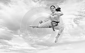 teen girl practicing karate. teen child jump on sky background. teen kid practicing martial art