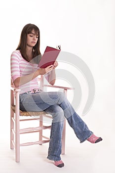 Teen Girl Reading book in Chair