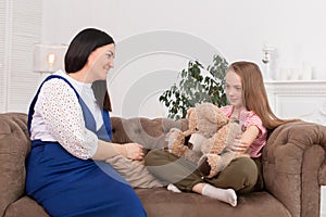Teen girl on reception at the psychotherapist. Psychotherapy session for children. The psychologist works with the patient. Girl