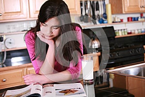 Teen girl relaxing in kitchen