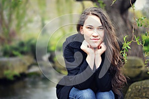 Teen Girl Resting Head on Hands by Pond