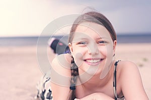 Teen girl resting lying on the beach