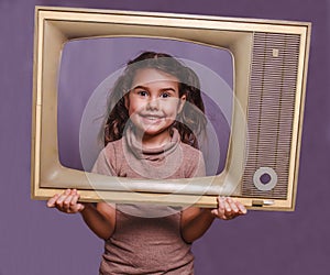 Teen girl retro child framed television frame smiling on gray ba