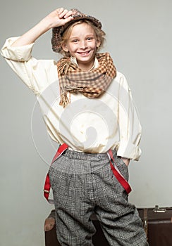 Teen girl in retro male suit. retro fashion model. Vintage suspender. old fashioned child in beret. street kid with