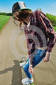 Teen girl rides a longboard