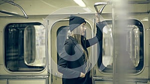 Teen girl rides the metro at night