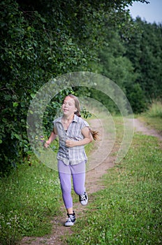 Teen girl running in forest