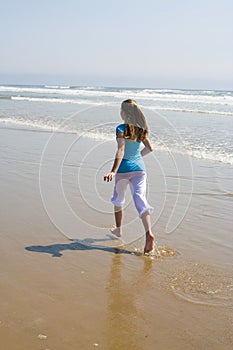 Teen Girl Running in the Surf