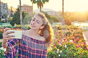 Teen girl selfie photograph in a city park