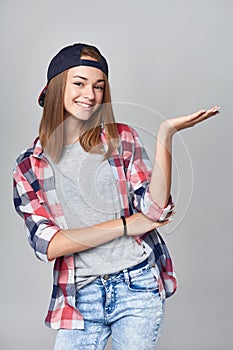 Teen girl showing empty copy space open hand palm