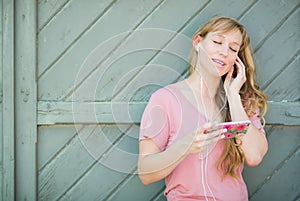 Teen Girl Singing Along to the Music on her Smartphone