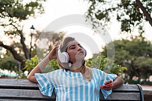 Teen girl singing and listening music from a smartphone