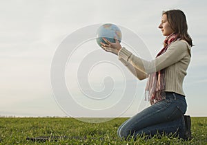 Teen girl sitting with a globe