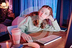 Teen Girl Sitting Relaxed At Desk In Her Room