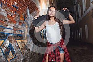 Teen girl with skate board, urban lifestyle.