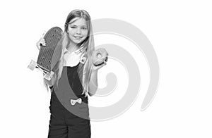 teen girl with skateboard and donut isolated on white, copy space. photo