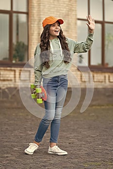 teen girl with skateboard outside, hello. teen girl with skateboard at the street. photo