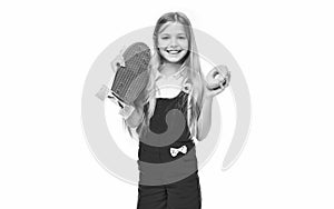 teen girl with skateboard and yummy donut in studio. teen girl with skateboard photo